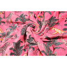 Folded pink velvet showing rich texture and forest scene pattern
