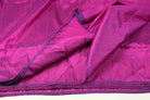 Fuchsia Magenta dupion silk fabric draped open to display colour variation, iridescent sheen, and natural slub texture