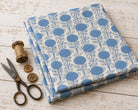 Powder blue block printed cotton fabric folded for sewing and quilting projects