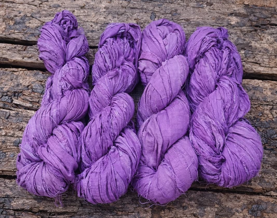 Bundle of violet sari silk ribbon skeins made from recycled silk fabric.