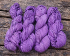 Bundle of violet sari silk ribbon skeins made from recycled silk fabric.