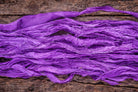 Long length of violet sari silk ribbon displaying rich colour and soft texture.