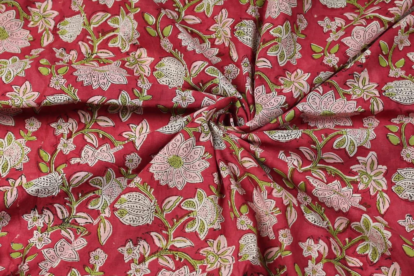 Raspberry Lotus Vine floral block print cotton fabric gathered to display drape and movement
