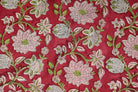 Close-up of Raspberry Lotus Vine block printed cotton fabric showing pink lotus flowers, green vines, and hand-printed details