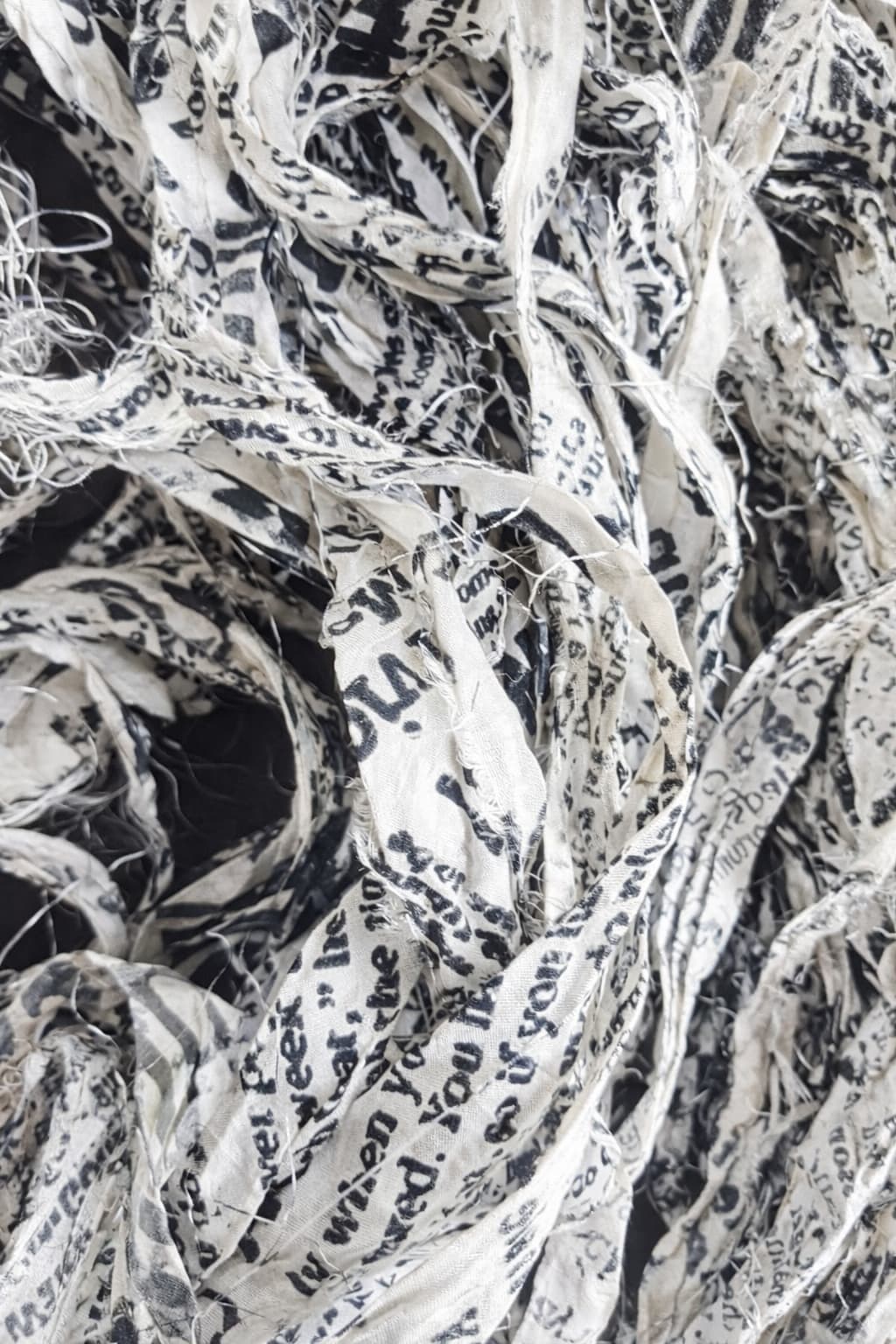 Close-up detail of newsprint sari silk ribbon texture
