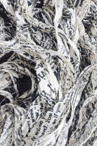 Close-up detail of newsprint sari silk ribbon texture