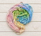 Coiled Pastel Meadow sari silk ribbon yarn showing multicolor pastel blend