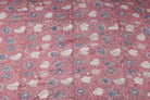 Rosewood Meadow block print cotton fabric featuring ivory and dusty blue wildflowers on a rose pink background