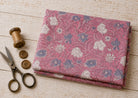 Rosewood Meadow hand block print cotton fabric in rose pink with ivory and dusty blue floral design