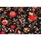 Close-up of red and maroon floral print on dark blue-black hand-printed cotton velvet