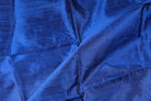 Royal Blue Dupion Silk Fabric displayed with soft folds revealing natural silk texture, lustrous finish, and rich jewel-blue colouring