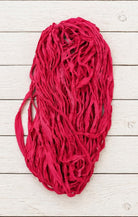 Loose strands of bright pink sari silk ribbon yarn