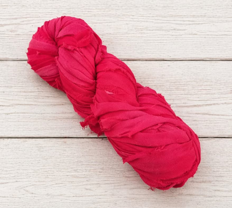 Single skein of Ruby Fuchsia recycled sari silk ribbon yarn
