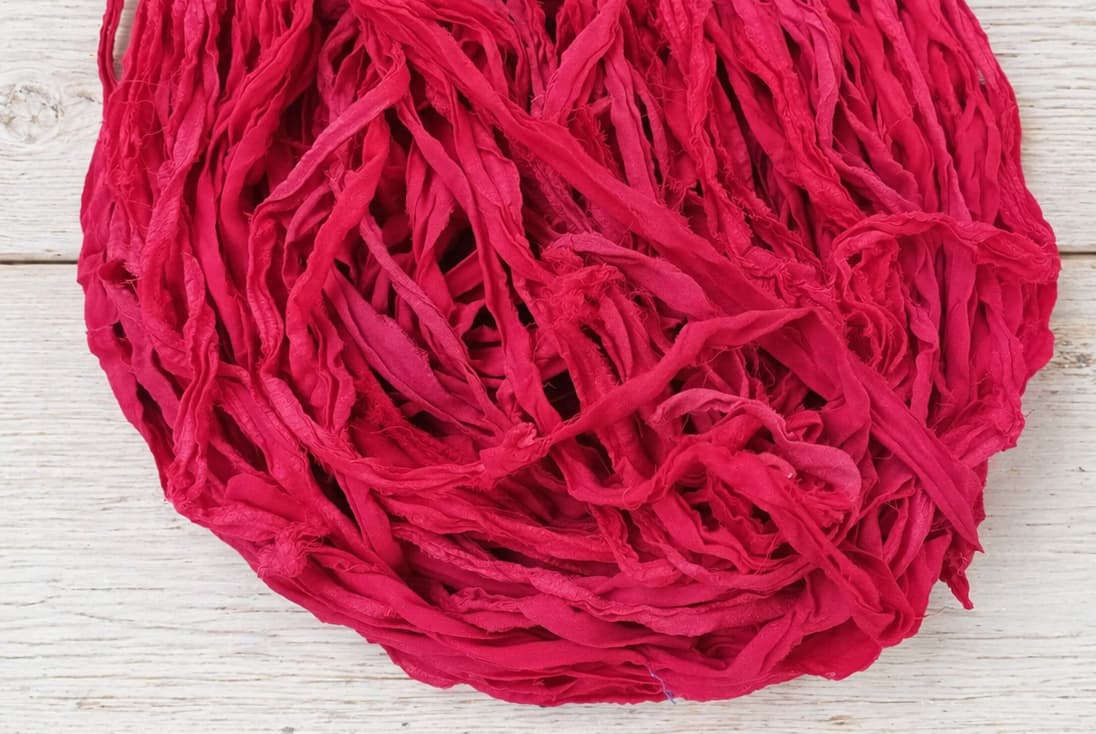 Close up texture of Ruby Fuchsia sari silk ribbon yarn