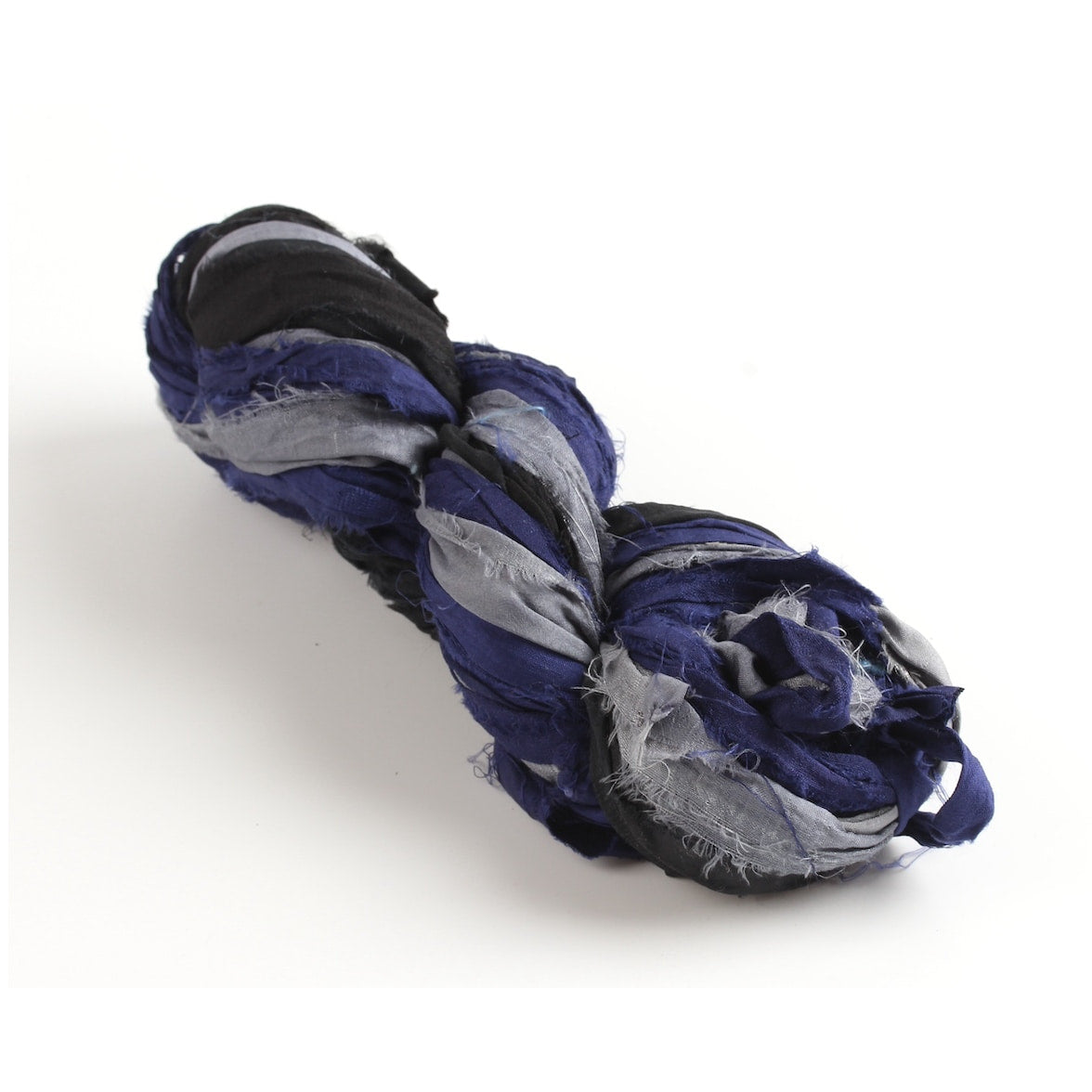 Black, grey, and navy blue sari silk ribbon skein on white background, handmade from recycled sari silk.