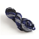Black, grey, and navy blue sari silk ribbon skein on white background, handmade from recycled sari silk.