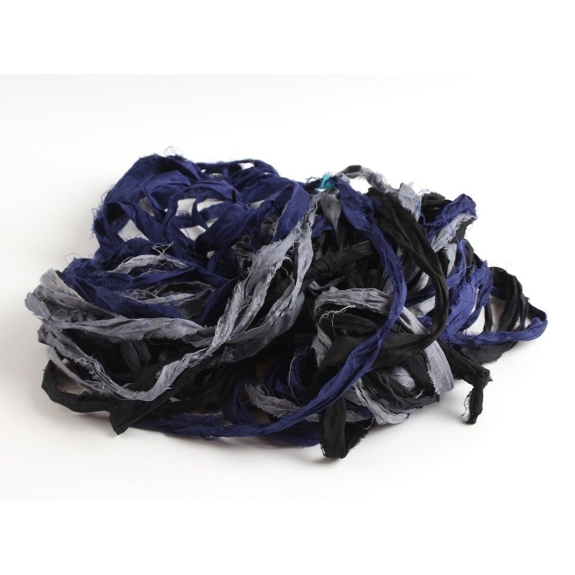 Black, grey, and navy blue sari silk ribbon displayed open, showing texture and frayed edges.