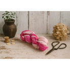 Flat lay of dark and pastel pink sari silk ribbon with styled props, eco-friendly handmade ribbon.
