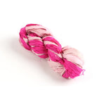 Dark and pastel pink sari silk ribbon skein on white background, handmade recycled silk ribbon for crafts.