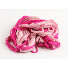 Dark pink and pastel pink sari silk ribbon opened to show handmade frayed edges and natural silk feel.