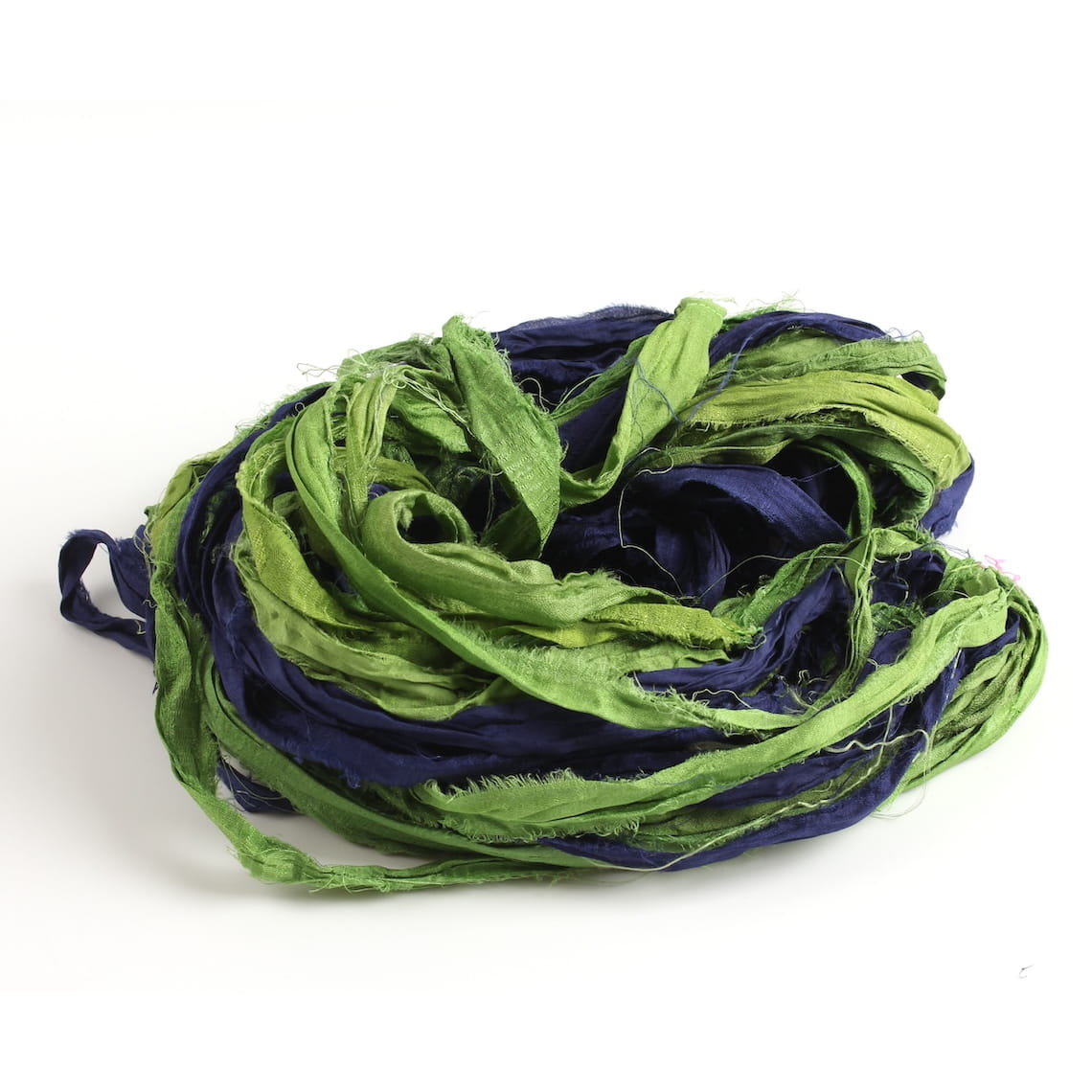 Green and blue sari silk ribbon displayed open, showing frayed edges and natural silk texture.