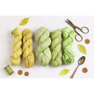 Assorted lime and green sari silk ribbons in various shades displayed together – handmade recycled silk ribbon collection