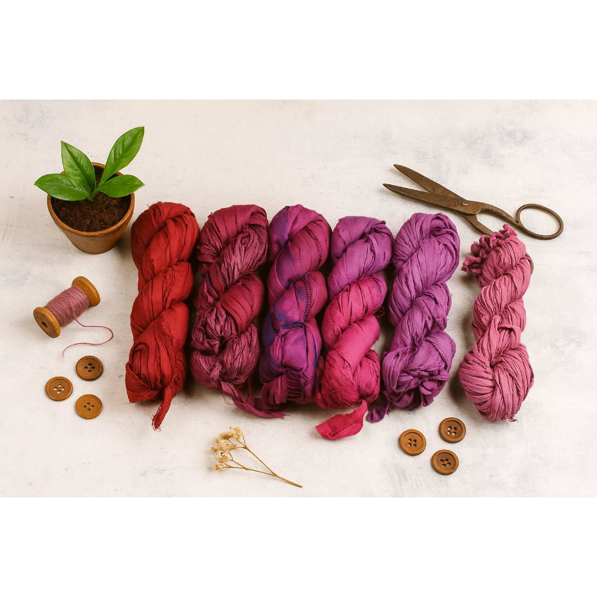 Assorted red and purple sari silk ribbon shades on flatlay display