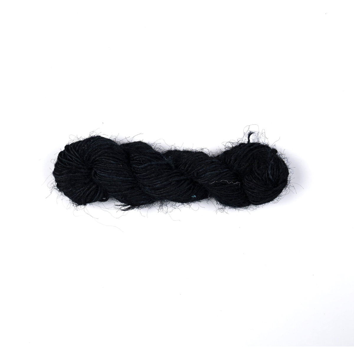 Deep, rich black sari silk yarn hand-spun from recycled silk. Luxurious texture and natural sheen, perfect for elegant weaving or crochet projects.