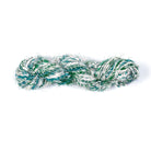 Green and white Sari Silk Yarn – hand-spun recycled silk yarn skein.