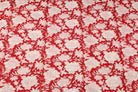 Scarlet red floral block print cotton fabric featuring repeating ivory flowers and botanical motifs