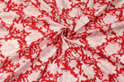 Scarlet red block print cotton fabric draped to showcase floral pattern and soft cotton texture