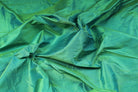 Seafoam Green Dupion Silk Fabric displayed in flowing folds showing its fresh colour and luxurious silk sheen