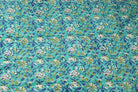 Seafoam Wildflower Trail hand block printed cotton fabric featuring ivory flowers, navy vines, and olive green botanical details on a seafoam background
