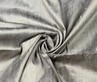 Silver Pewter dupion silk fabric arranged in a swirl highlighting metallic sheen, natural slubs, and raw silk texture