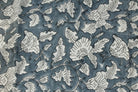 Close-up of Slate Meadow Bloom block printed cotton fabric showing ivory flowers, leaves, and trailing vine details