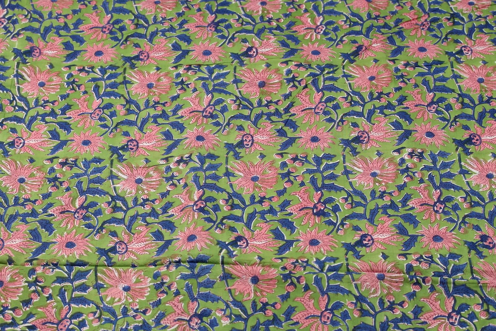 Apple green floral vine block print cotton fabric showing repeating botanical pattern