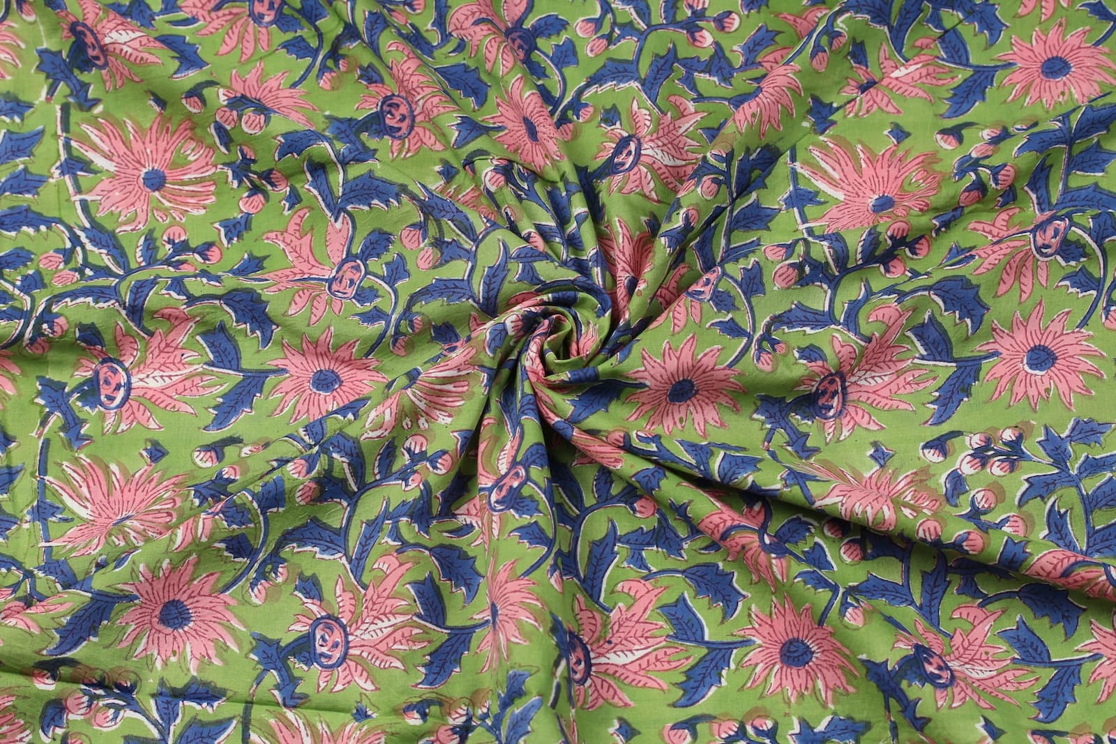 Apple green floral vine block printed cotton fabric draped to show texture and movement