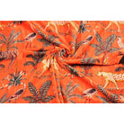 Folded orange velvet showing luxurious texture and jungle print details