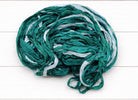 Coiled Ocean Mist sari silk ribbon yarn showing teal and aqua shades