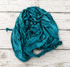 Loose bundle of Peacock Lagoon sari silk ribbon yarn showing vibrant turquoise tones