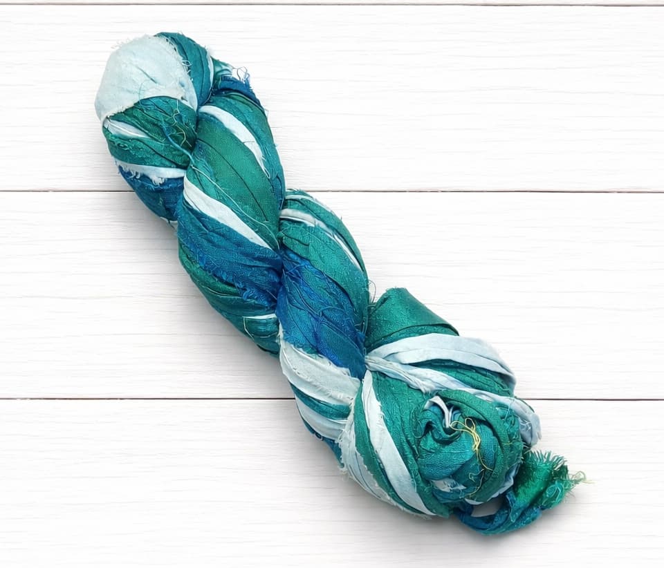 Twisted skein of Ocean Mist recycled sari silk ribbon yarn
