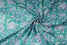 Turquoise hand block printed cotton fabric gathered to display drape and floral botanical design
