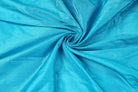 Turquoise Dupion Silk Fabric arranged in elegant swirling folds highlighting its lustrous finish and natural dupion silk texture