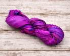 Single skein of Wild Orchid sari silk ribbon in bold fuchsia and purple tones.